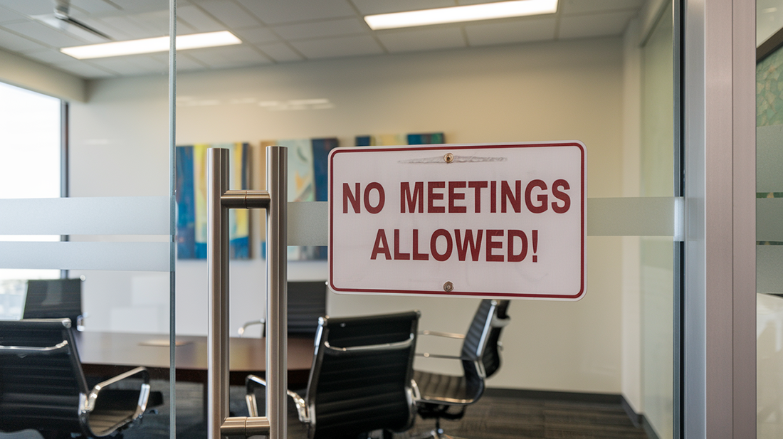 How to launch an app with zero meetings? This image shows a close up of a glass office door, looking into a conference room. on the door there is a sign that says "No meetings allowed!"